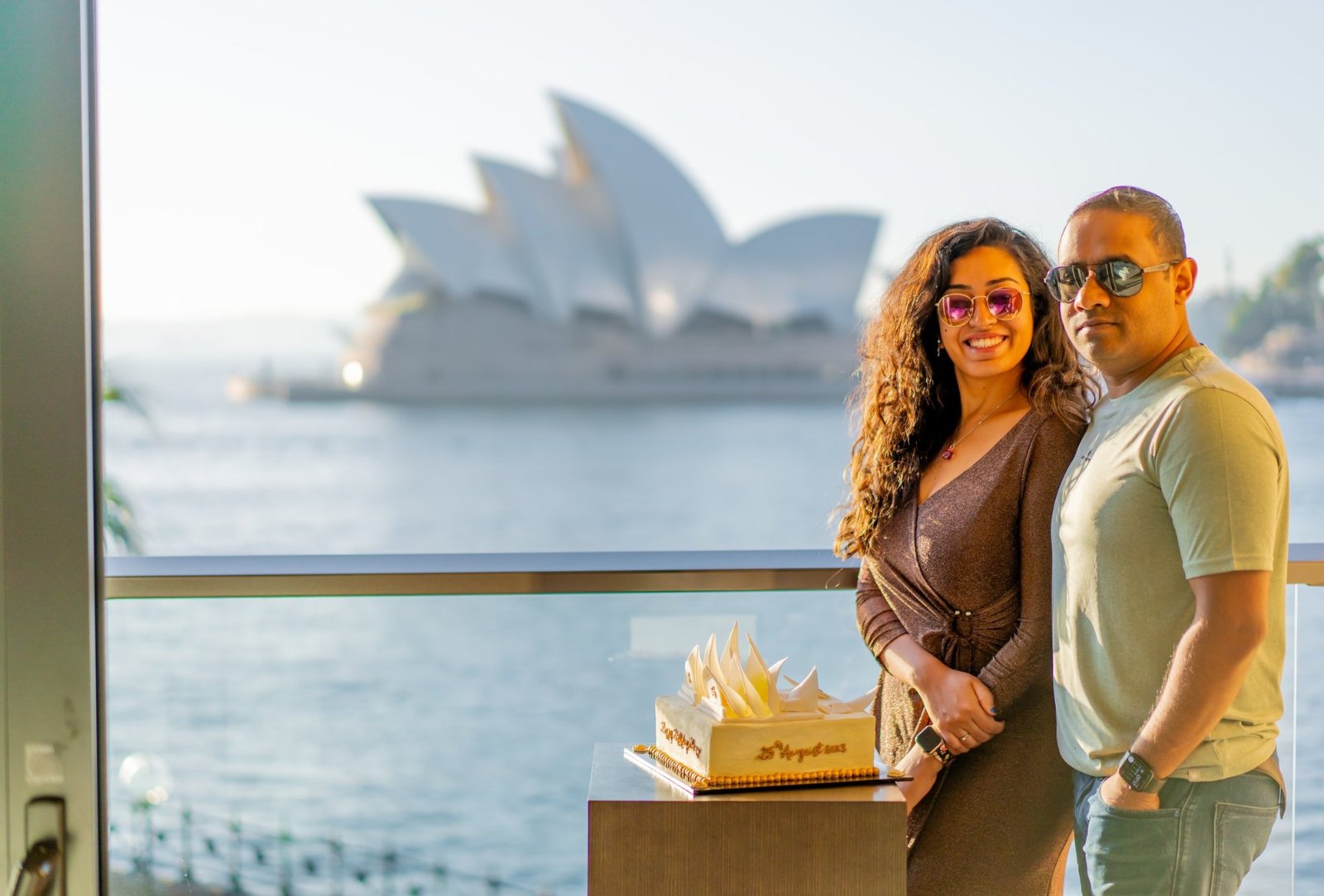 Meenu and Praddy on our balcony at sunrise, with the Sydney Opera House across the water