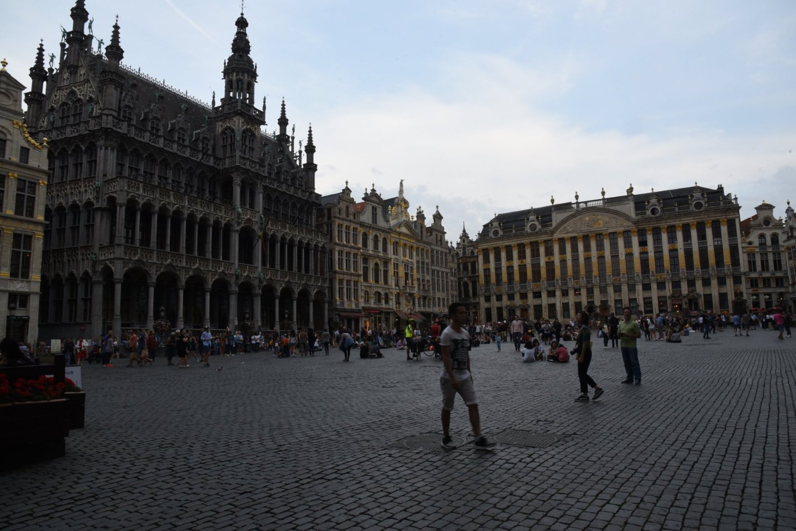 The Grand-Place at dusk, with the dark Gothic front of the King's House and the guild houses beyond