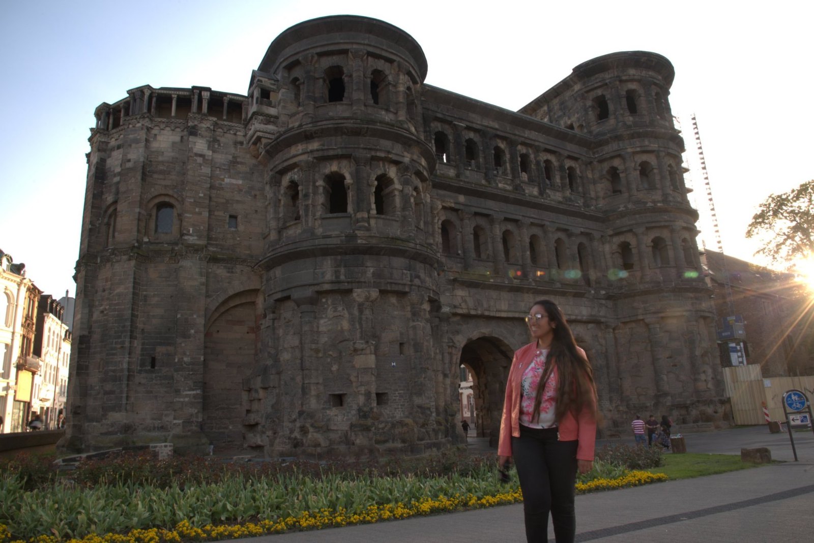 Meenu in front of the Porta Nigra, Trier's blackened Roman gate, in the evening sun