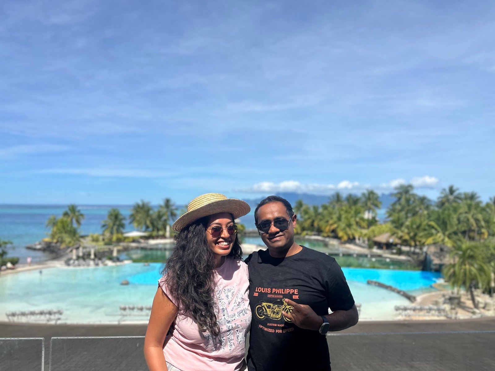 Meenu and Praddy above the InterContinental Tahiti's turquoise pool, with Moorea on the horizon