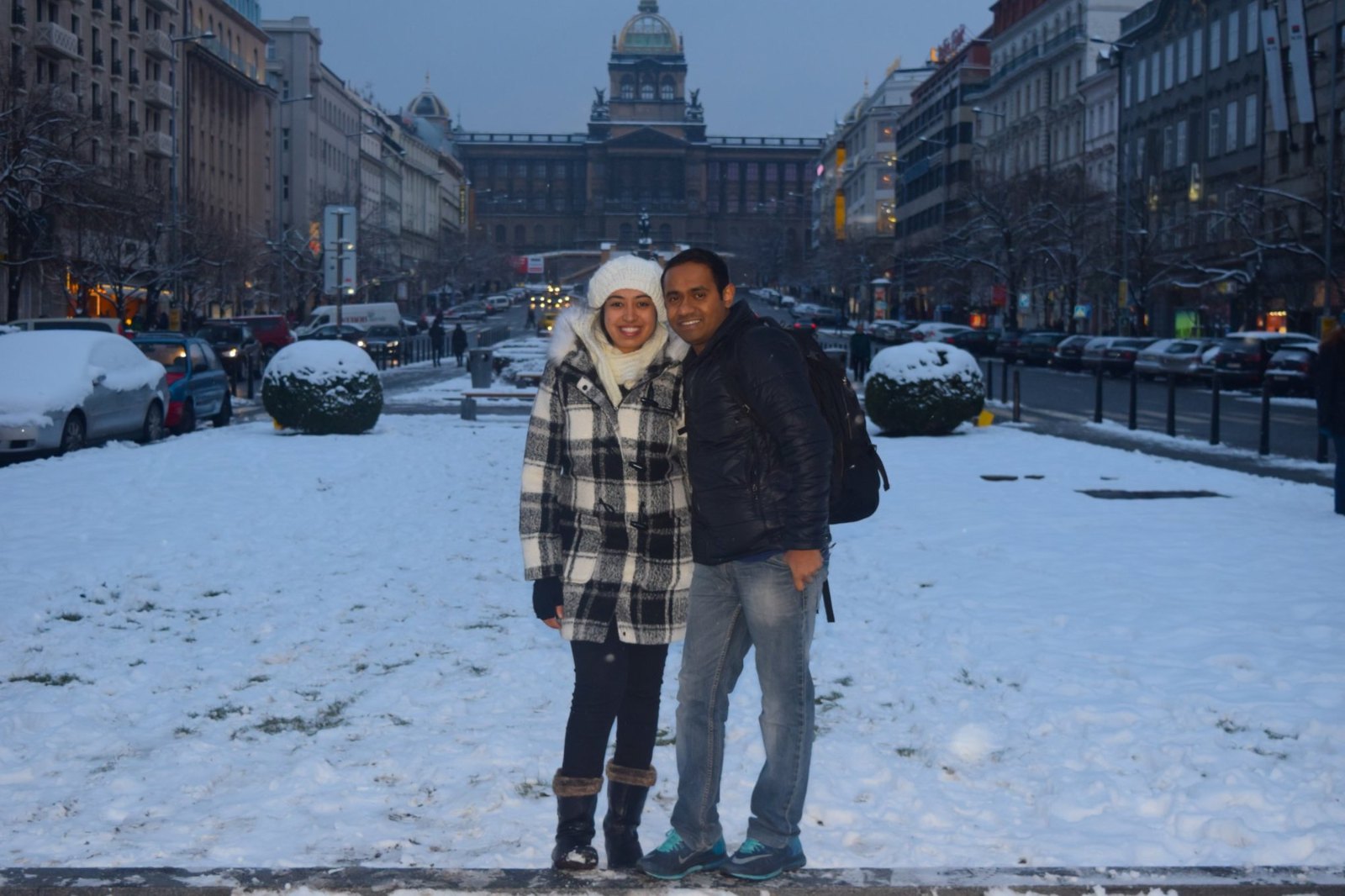 Meenu and Praddy in the snow on Wenceslas Square, with the National Museum at the far end