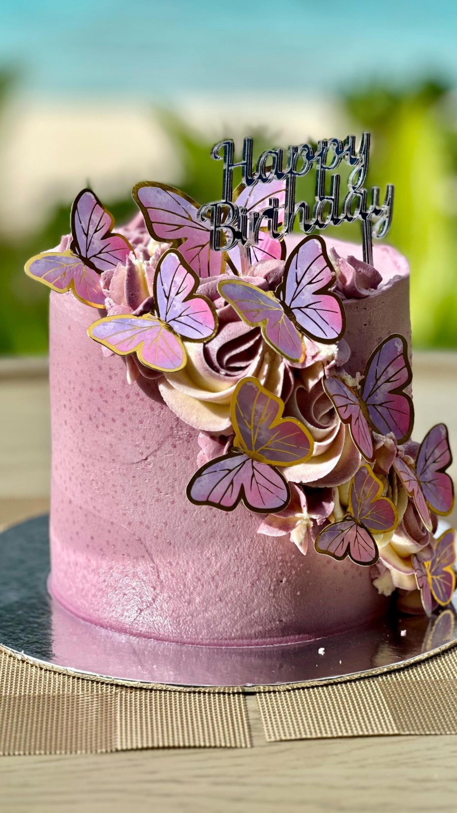 Meenu's lilac birthday cake, covered in purple and gold butterflies