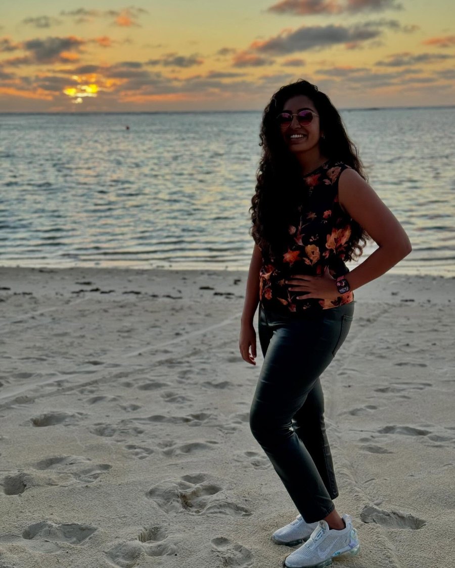 Meenu on the beach at Pacific Resort Aitutaki as the sun sets behind her