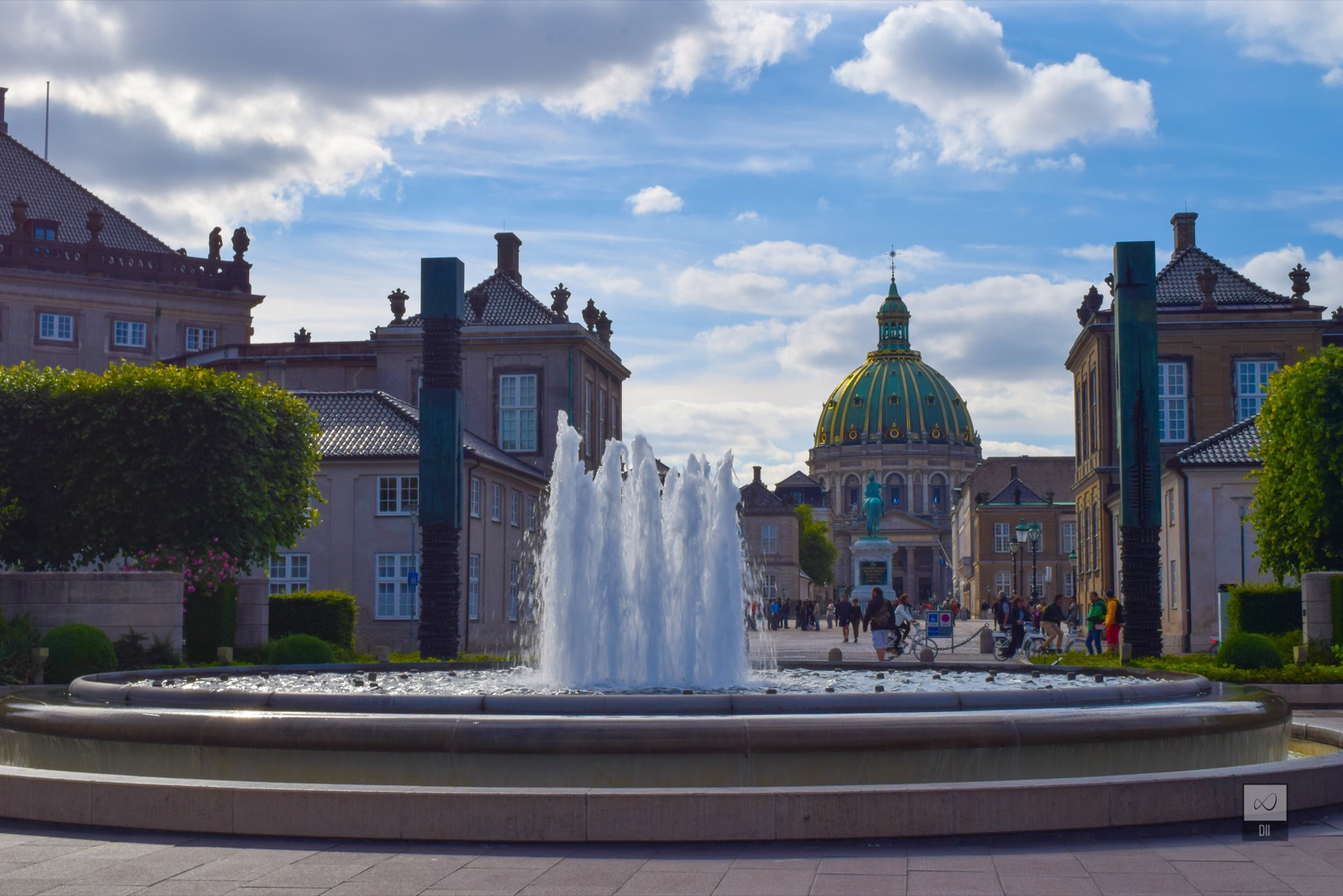 A fountain between Amalienborg's palaces, with the Marble Church's green dome beyond