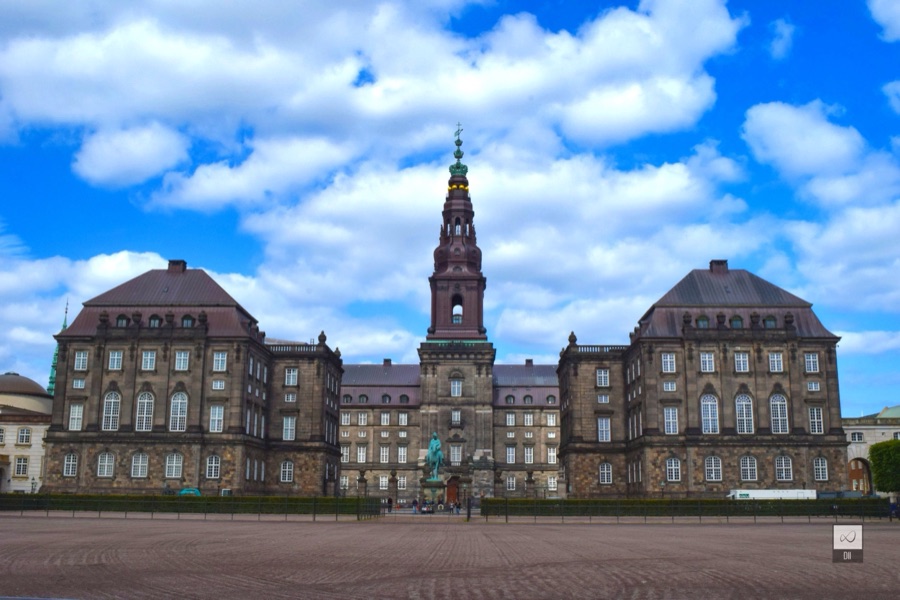 Christiansborg Palace and its tall tower across a wide, empty square
