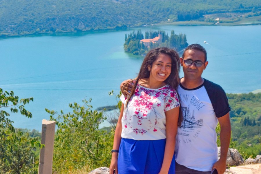 Meenu and Praddy at a viewpoint high above the river, with the island monastery of Visovac behind