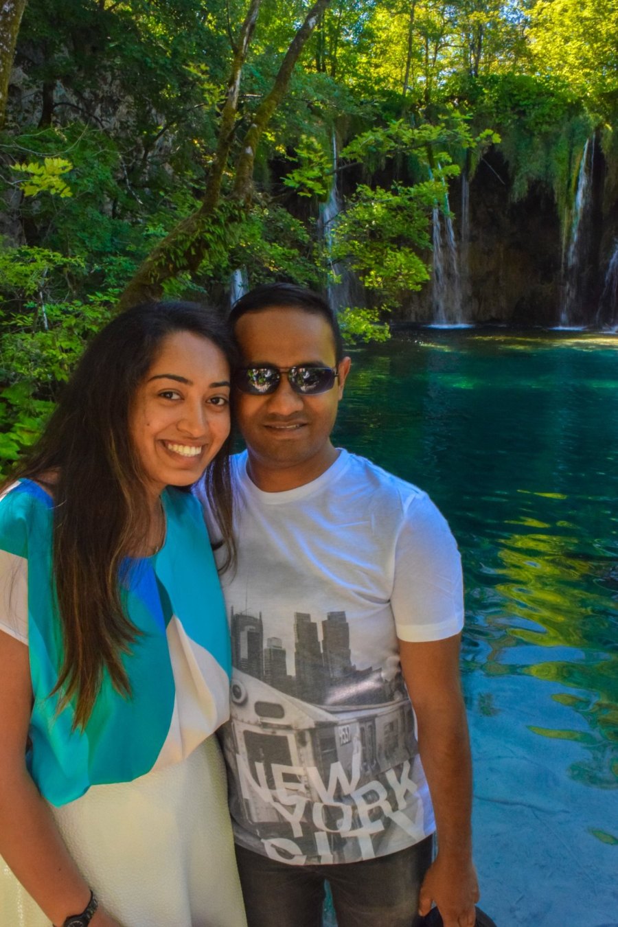 Meenu and Praddy cheek to cheek beside the turquoise water at Plitvice