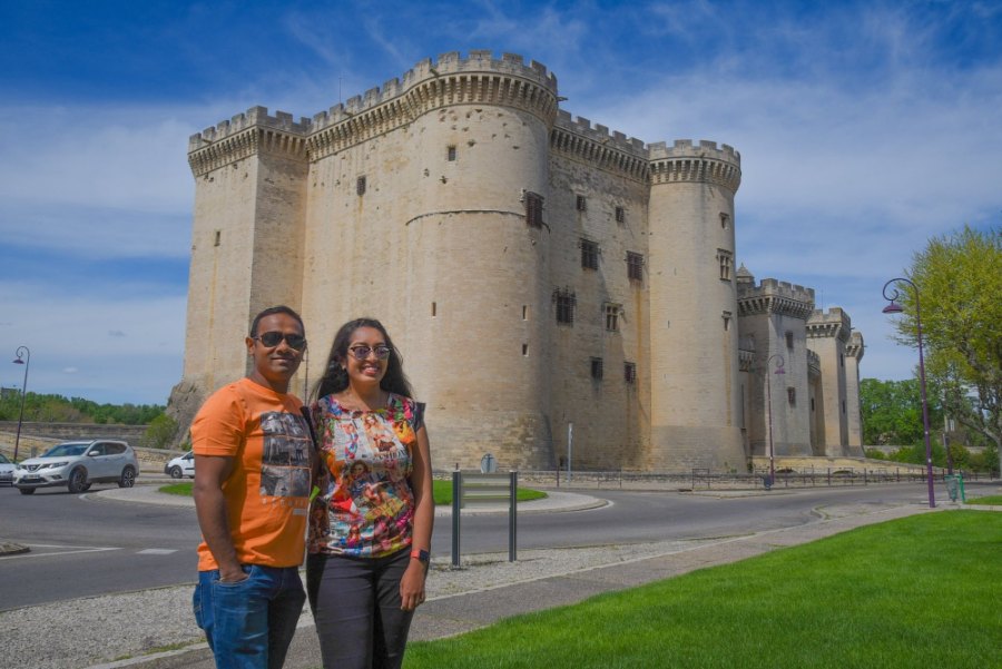 Meenu and Praddy in front of the castle at Tarascon, with its round towers behind them