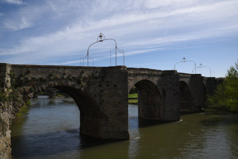 The old stone bridge over the river at Carcassonne, with iron lamp arches above its parapet