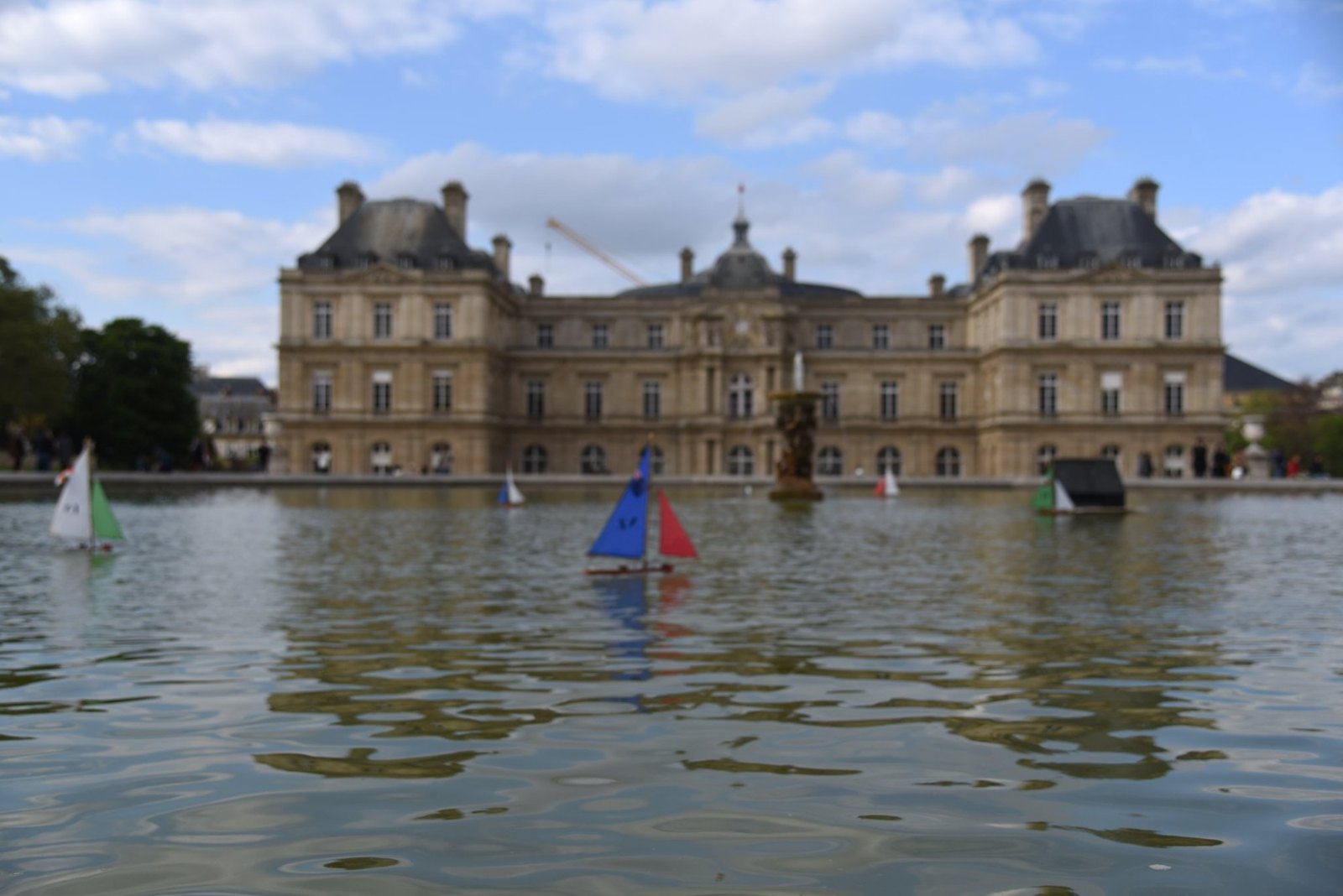 The Luxembourg Palace across the pond, with toy sailing boats on the water
