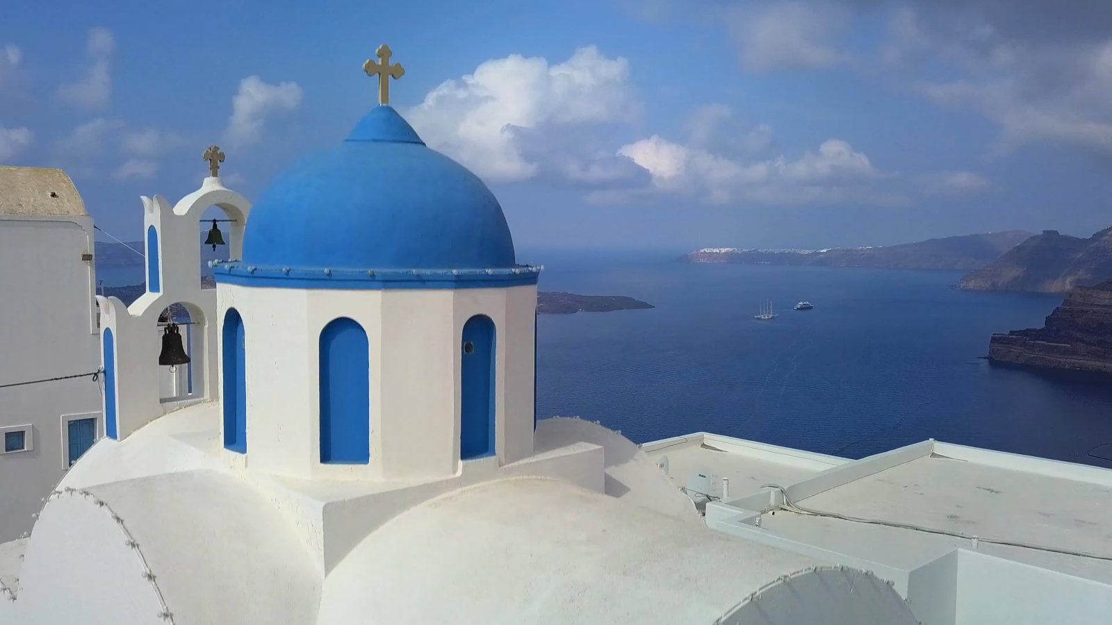 A blue-domed church above Santorini's caldera