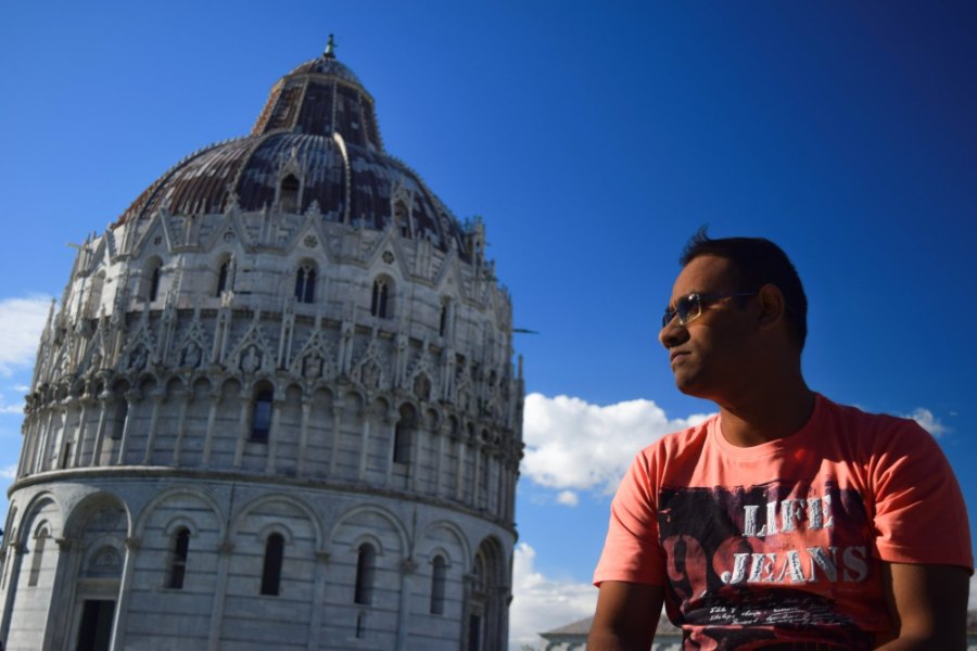 Praddy in profile beside the round marble Baptistery