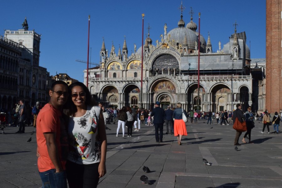 Meenu and Praddy in St Mark's Square, in front of the basilica's domes and arches
