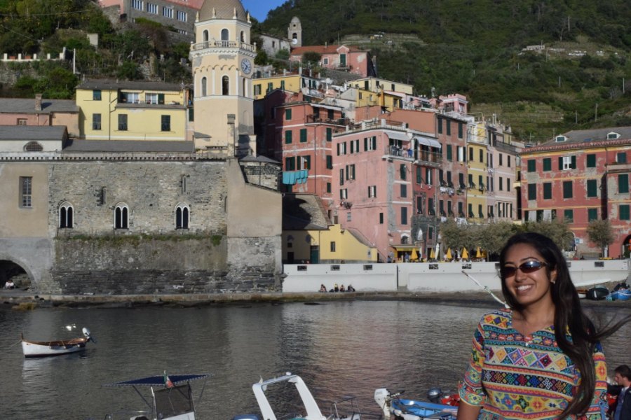 Meenu by Vernazza's harbour, with the church tower and pink and yellow houses behind