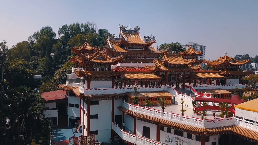 Thean Hou Temple's tiers of curved orange roofs on its wooded hilltop