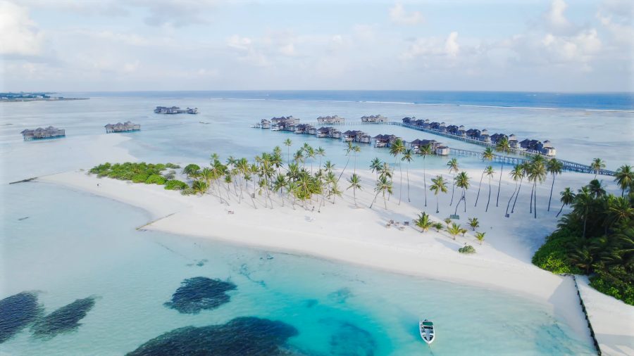 The island from above, with its long white sand spit and the villa jetties beyond