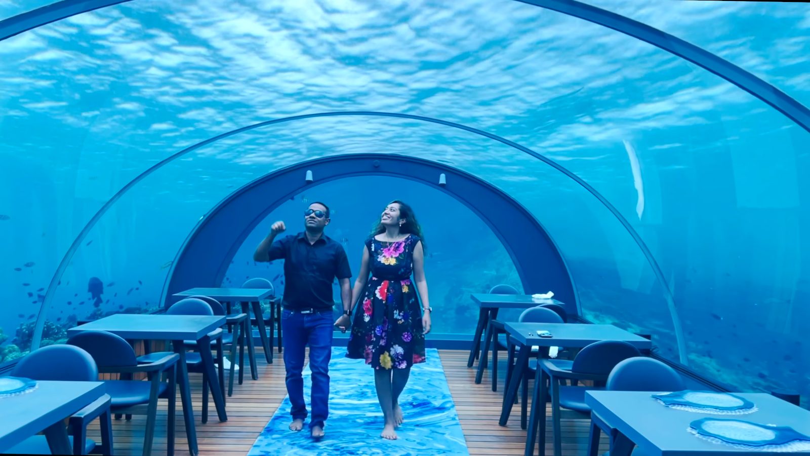 Meenu and Praddy walking through 5.8, the glass undersea restaurant