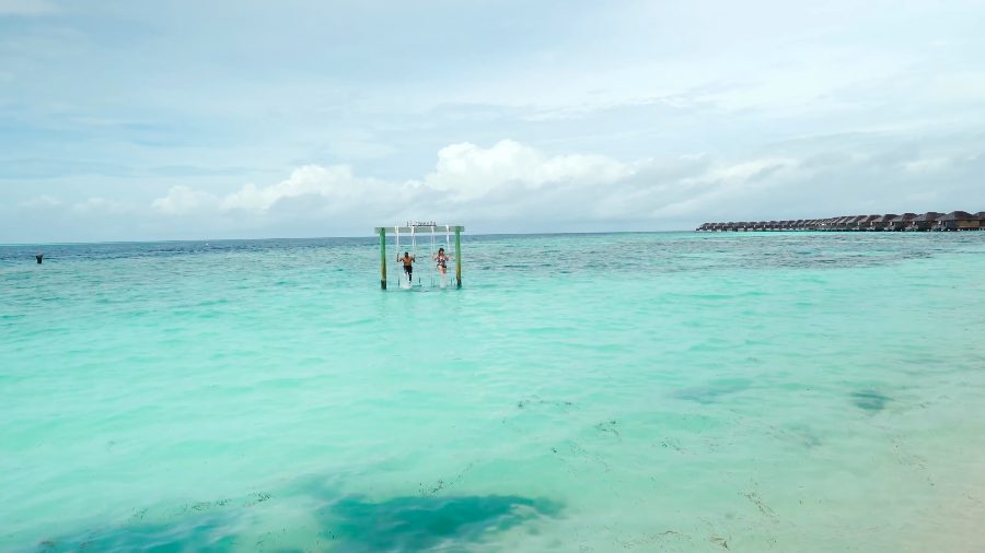 The swing standing in the shallow turquoise lagoon