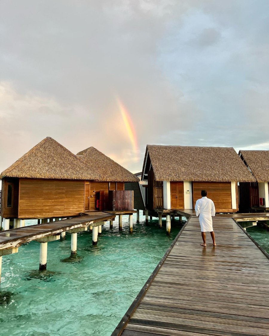 Kandolhu's thatched overwater villas along the wooden walkway