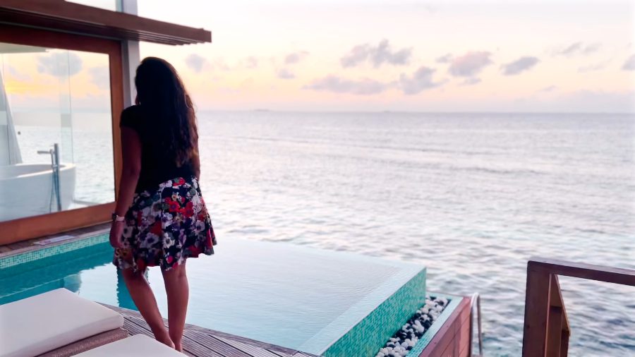 Meenu on the villa deck at sunset beside the pool