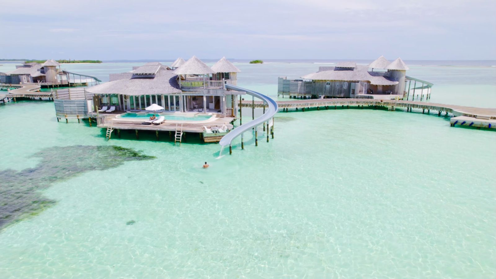 Soneva Jani's overwater villas with their water slides curling down into the lagoon