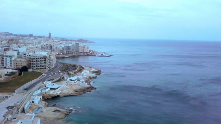Apartment blocks along the rocky shore, from the drone