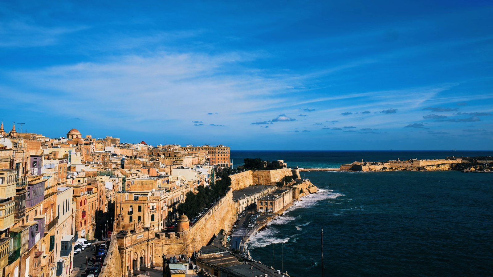 Valletta's limestone houses and bastions above the sea, from the drone