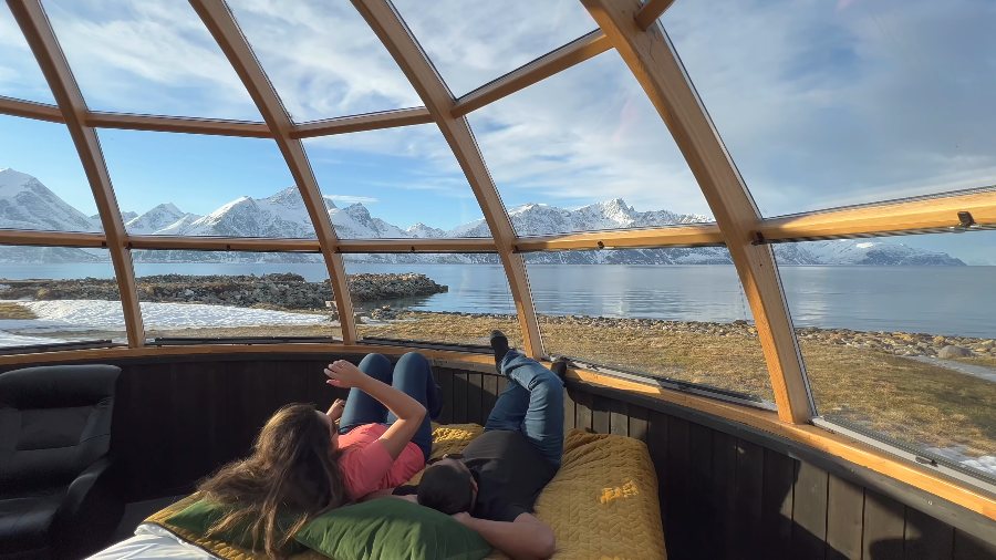 The two of us lying in the glass dome igloo, looking out at the fjord