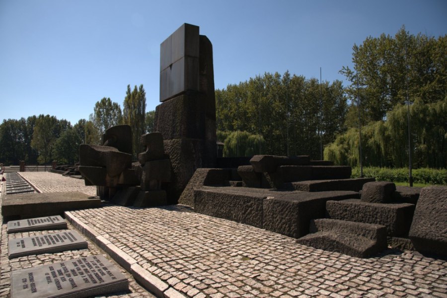 The memorial at Birkenau, a row of plaques in front of blocks of dark stone