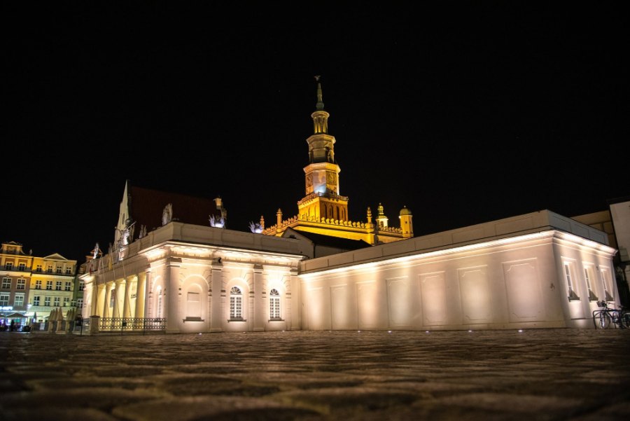 Poznań's Town Hall tower lit up above the Old Market Square at night