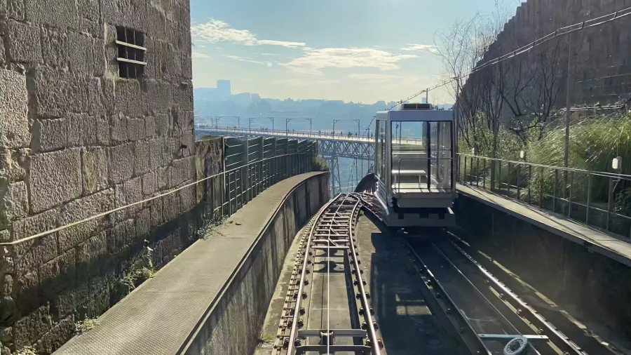 A Guindais funicular car on its steep track beside the old city wall
