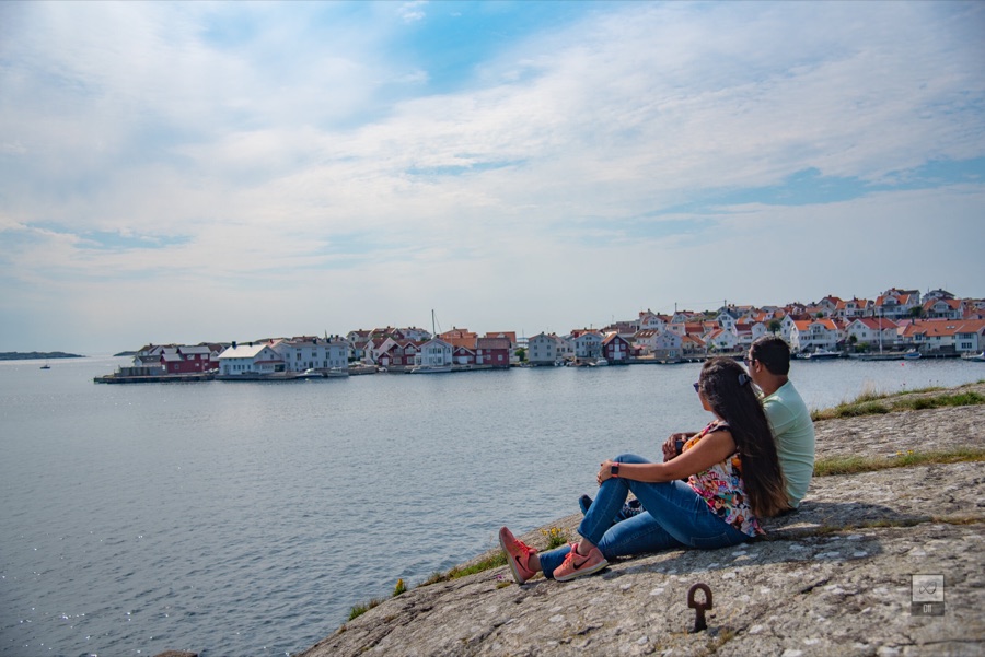 Meenu and Praddy sitting on the rocks, looking across the water to Klädesholmen