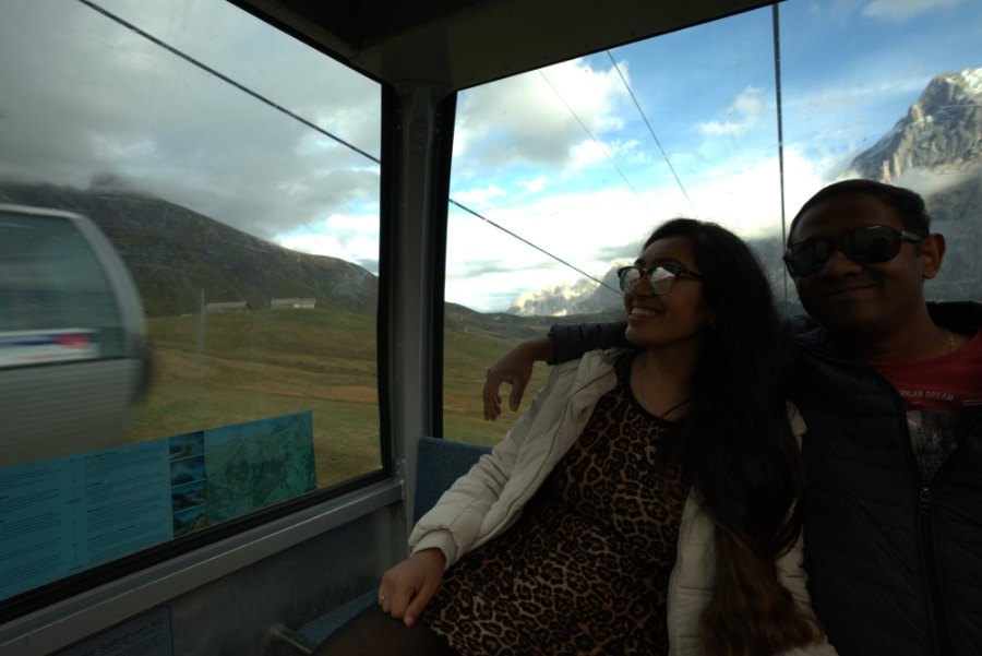 Meenu and Praddy side by side in the gondola, with the mountains through the window