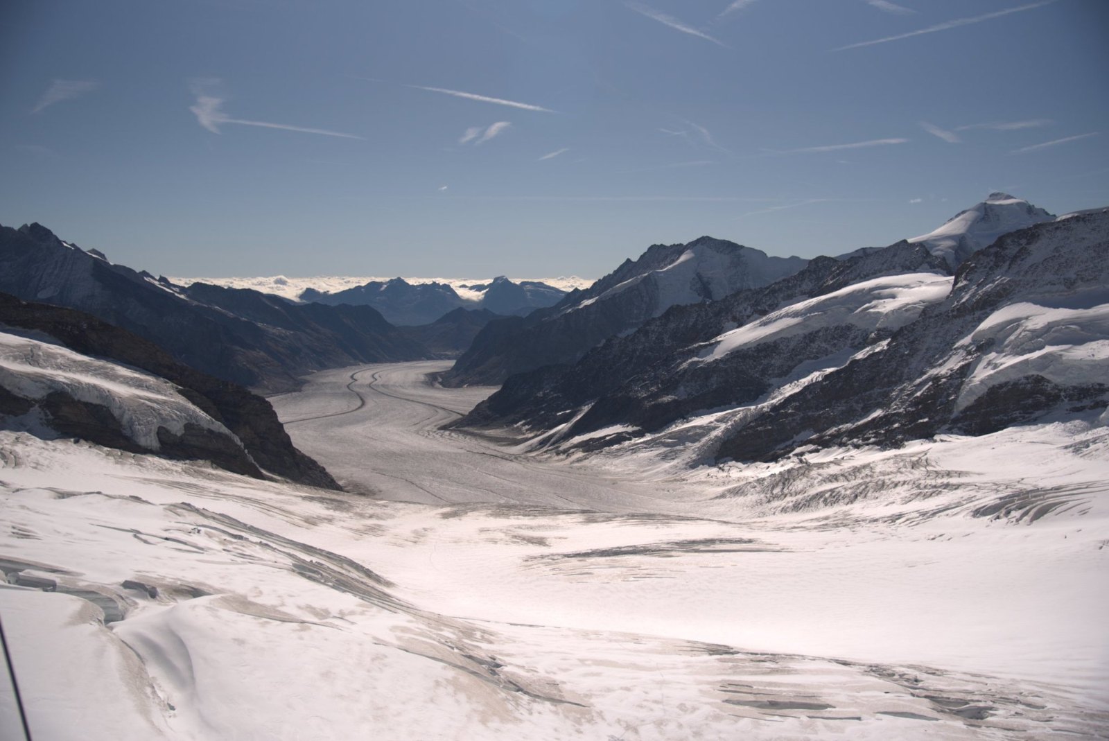 The Aletsch glacier stretching away between dark ridges under a clear sky