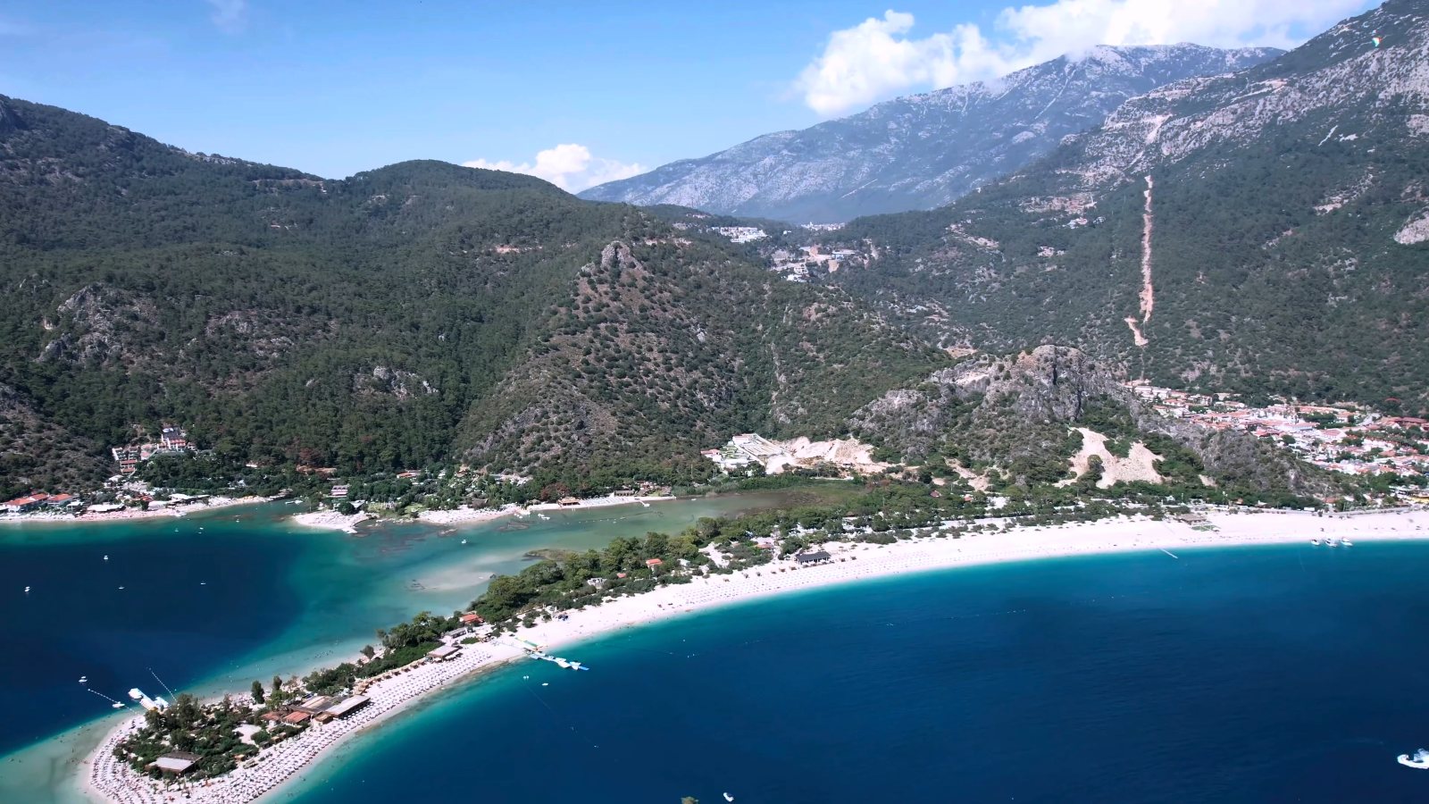 Ölüdeniz from high above, with the lagoon, the long white beach and the mountains behind