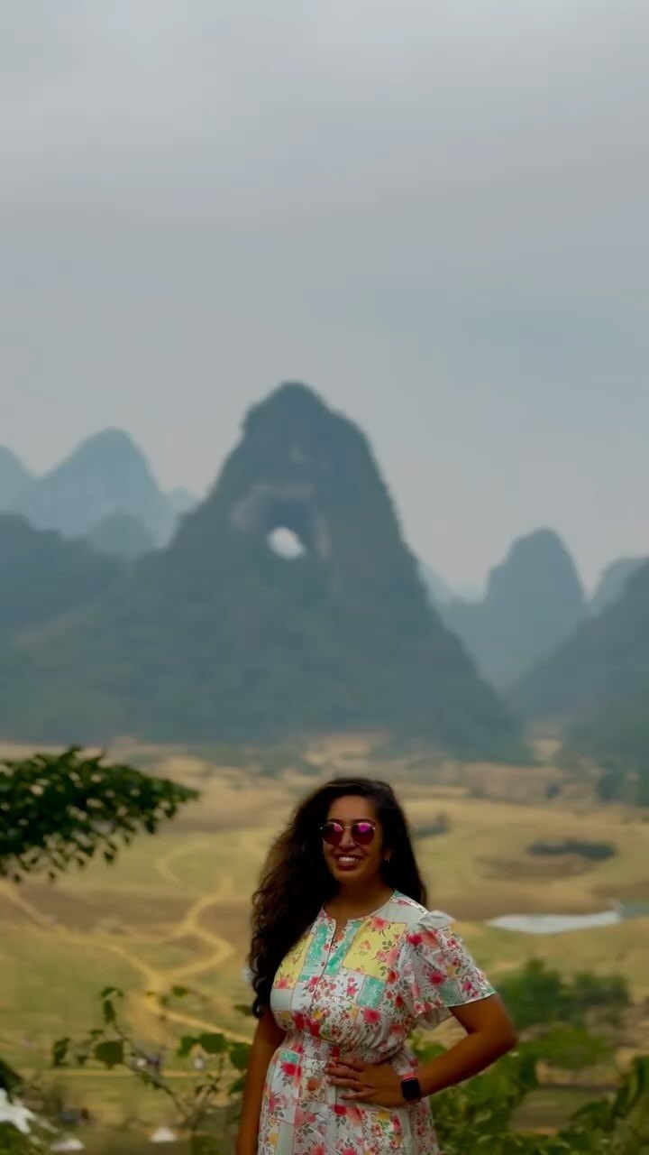 Meenu below Angel Eye mountain, a limestone peak with a hole right through it