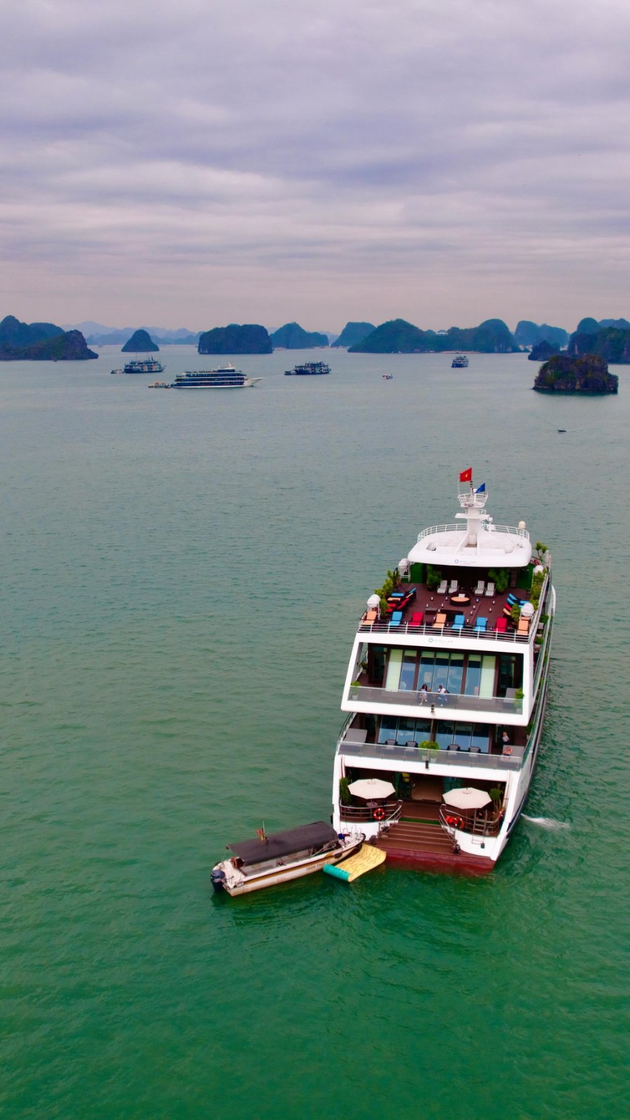 Looking down on the Stellar of the Seas on Ha Long Bay's green water, with limestone islands on the horizon