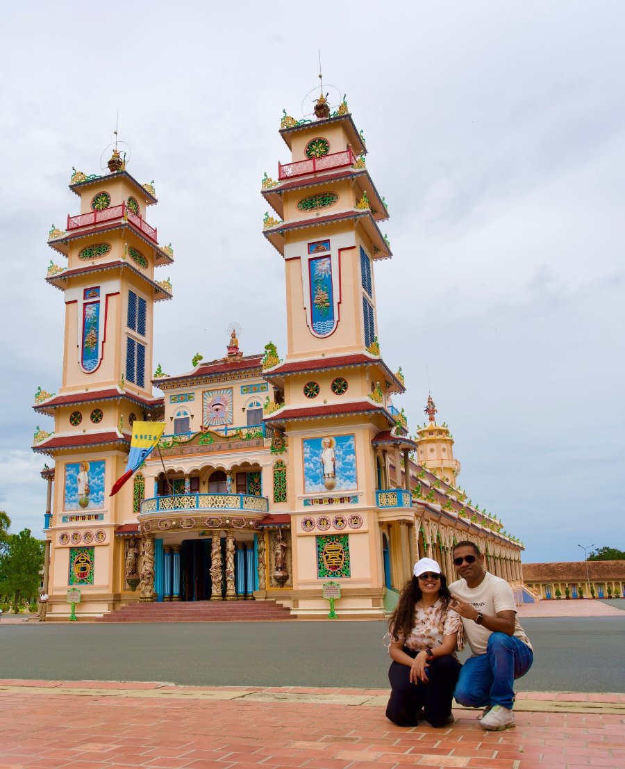 The two of us in front of the painted towers of the Cao Đài Holy See in Tây Ninh